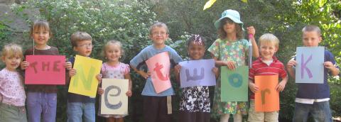 Children holding Network signs